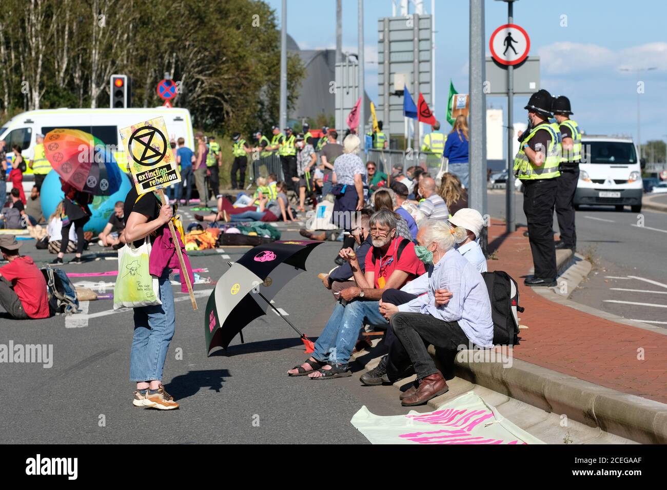 Cardiff, Wales, UK - Tuesday 1st September 2020 - Extinction Rebellion ( XR ) protesters block the road outside the Welsh Office in Cardiff Bay with a large Police presence looking on. XR have set up a base camp outside Cardiff City Hall in preparation for a week of action protesting against climate change and the future of society. Photo Steven May / Alamy Live News Stock Photo