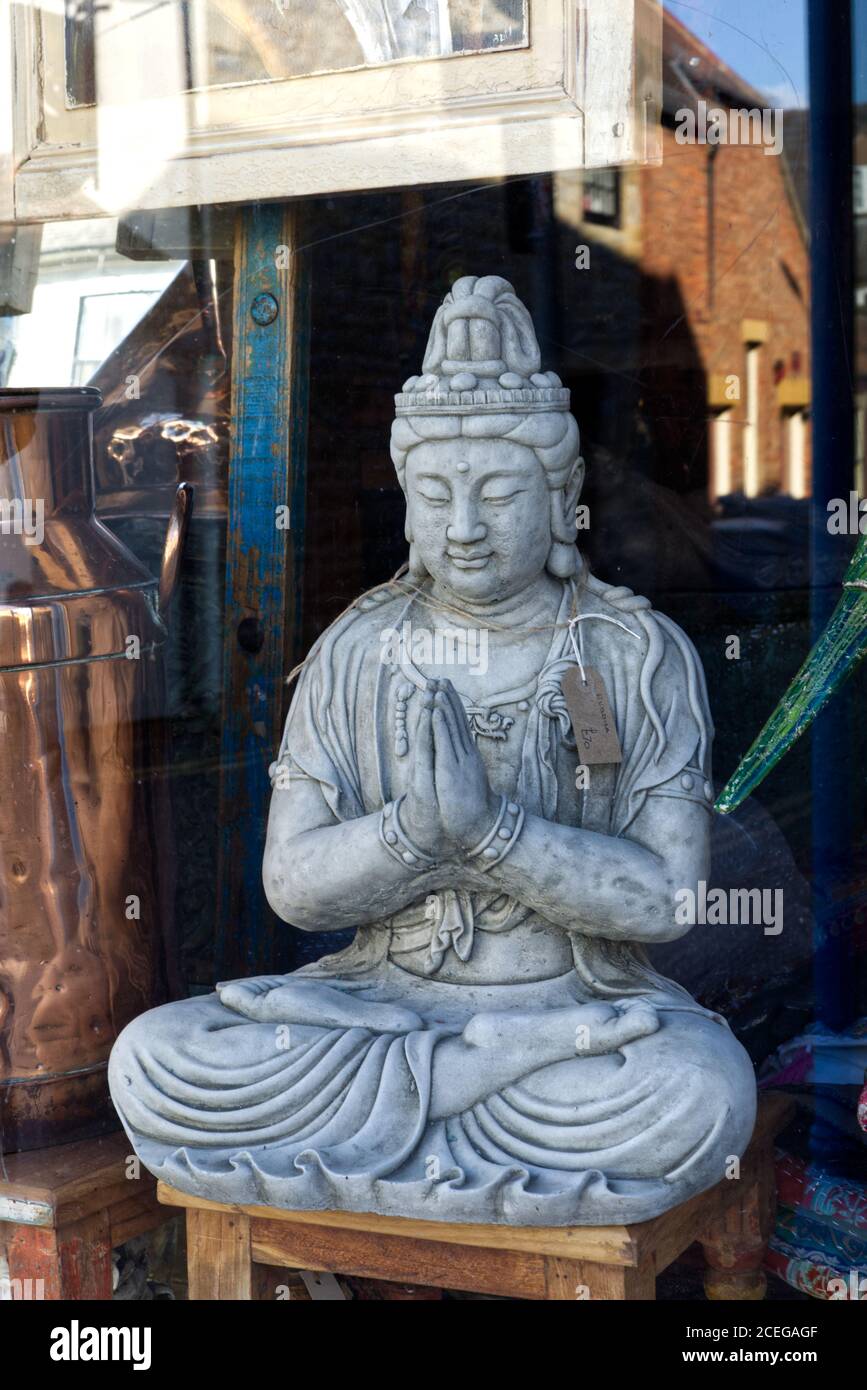 Buddha statue in a shop window Stock Photo