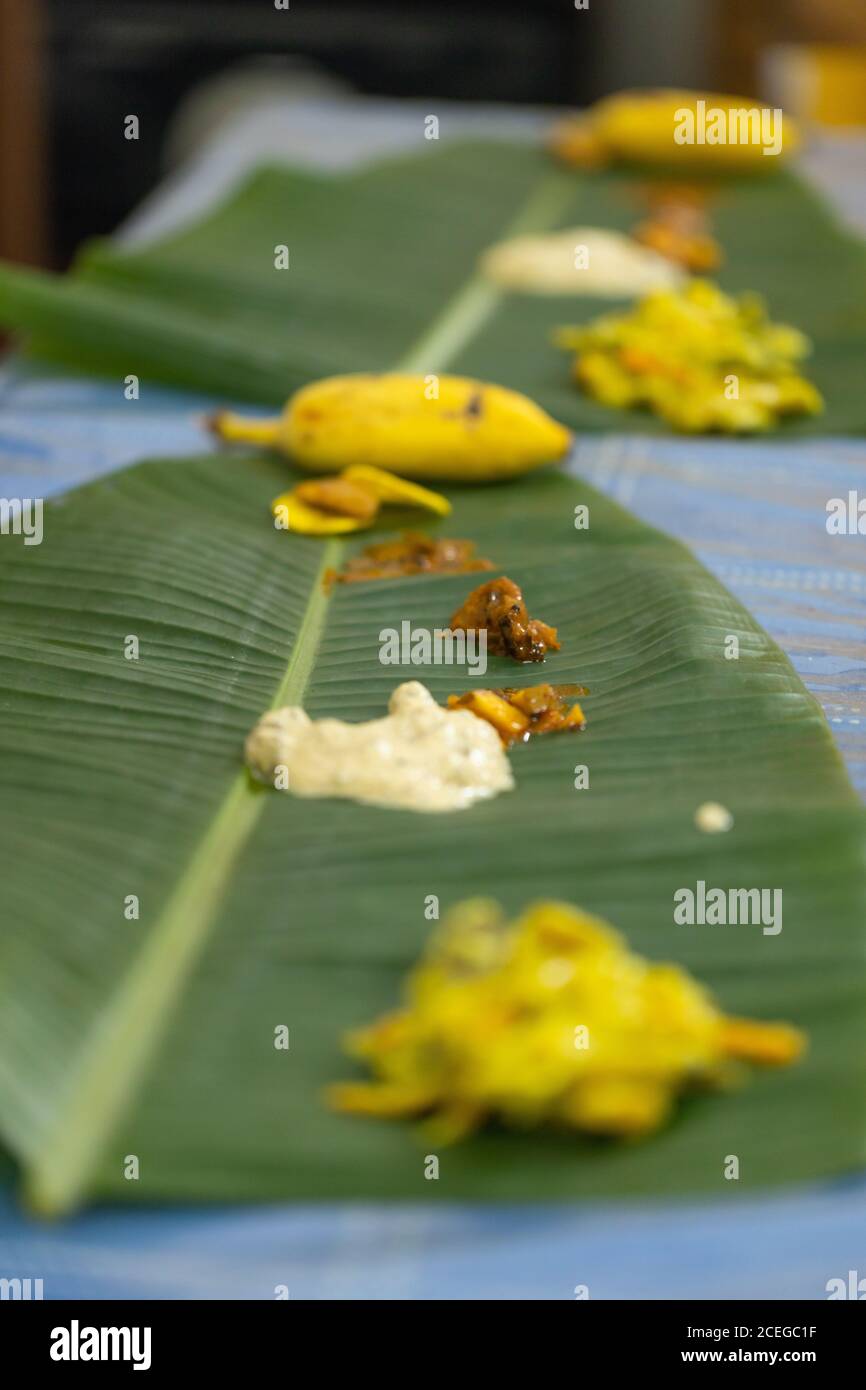 Traditional Kerala food laid out on a banana leaf during the Onam festival in Kerala India Stock Photo