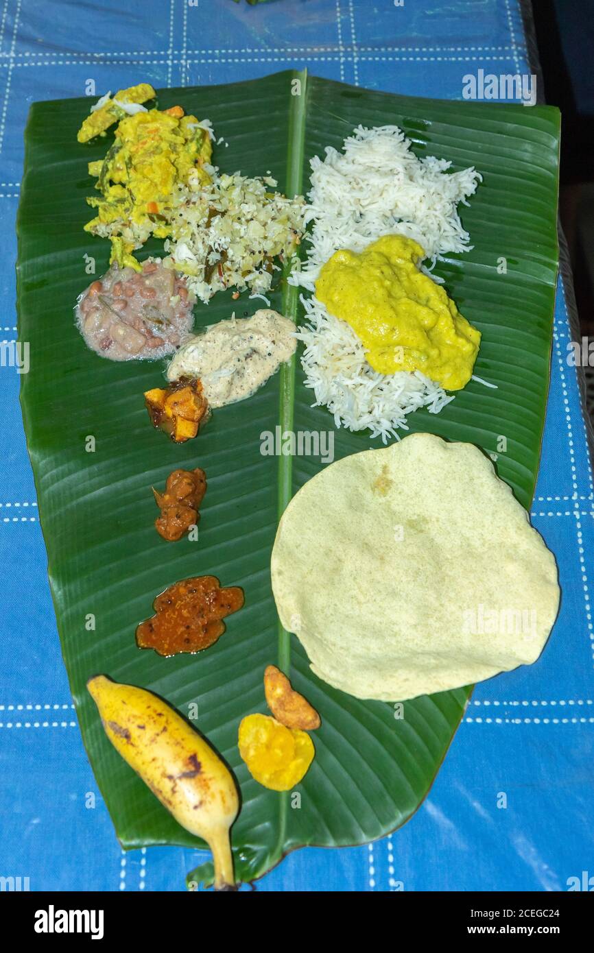 Traditional Kerala food laid out on a banana leaf during the Onam festival in Kerala India Stock Photo
