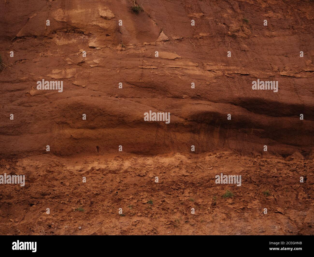 Abstract background of textured surface of rock in dark red brown color ...