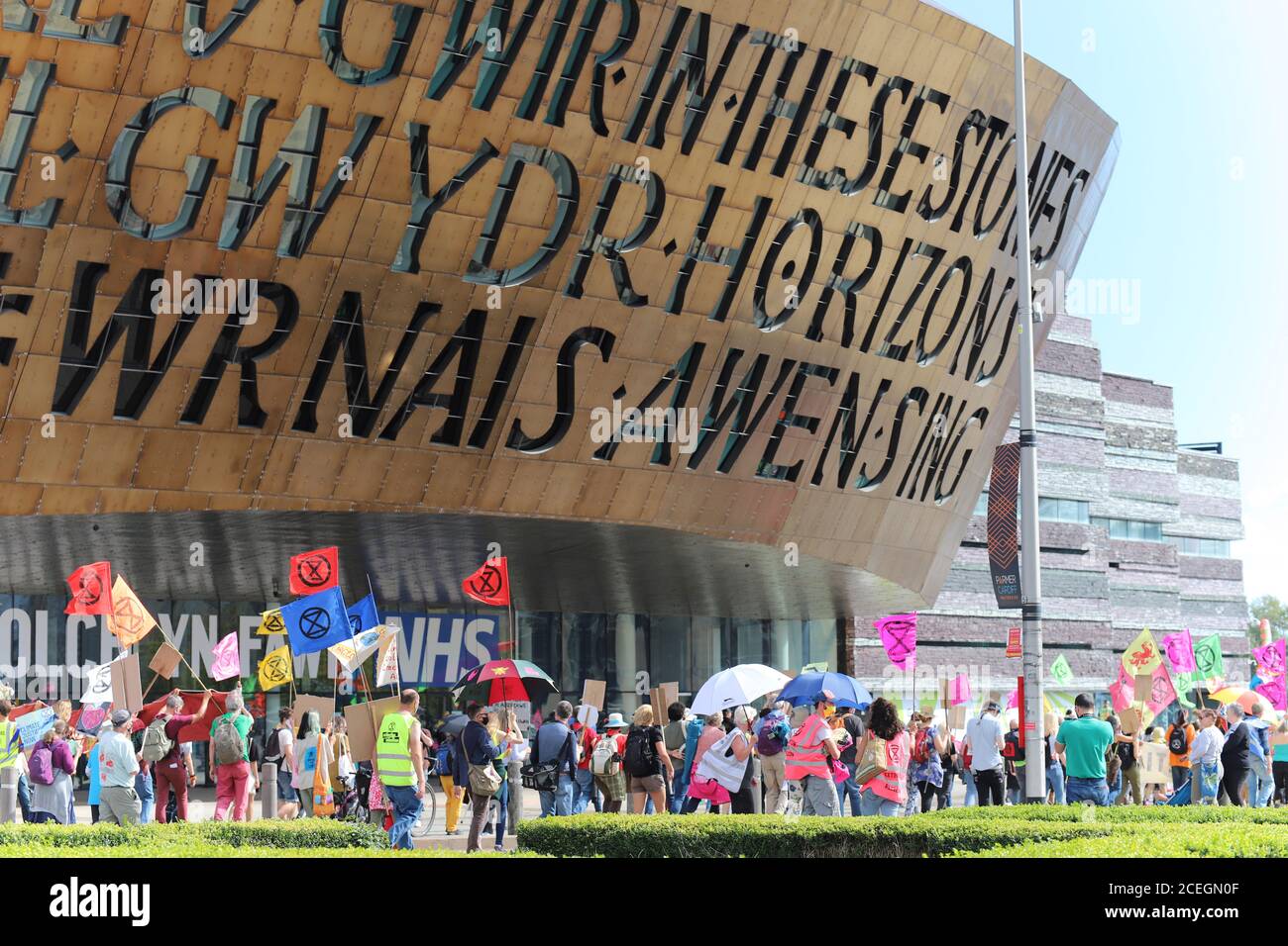 Cardiff, Wales, UK. 1st September 2020. Extinction Rebellion protestors take over Cardiff and march on the Senedd to demand a green recovery and passing of the CEE Bill on day one of a week of action. Protesters march around the old Senedd building Credit: Denise Laura Baker/Alamy Live News Stock Photo