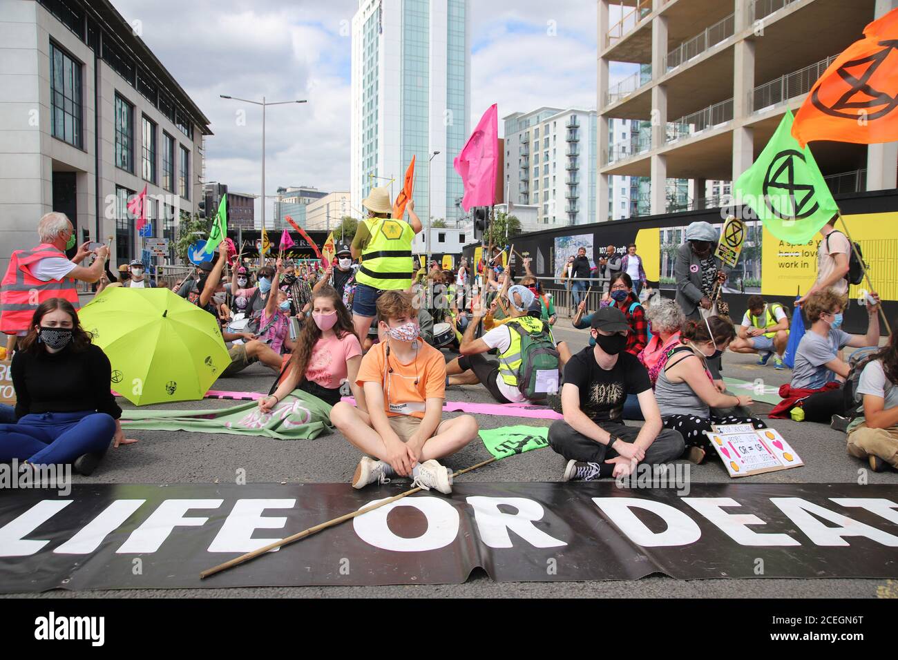 Cardiff, Wales, UK. 1st September 2020. Extinction Rebellion protestors take over Cardiff and march on the Senedd to demand a green recovery and passing of the CEE Bill on day one of a week of action. Protestors sit down and block the road showing banners saying Life or Death Credit: Denise Laura Baker/Alamy Live News Stock Photo