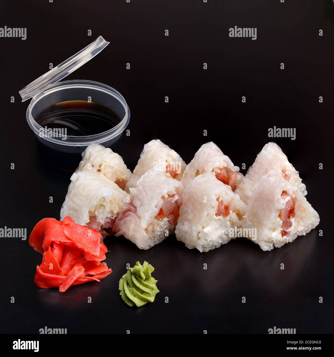https://c8.alamy.com/comp/2CEGNC0/traditional-delicious-fresh-soft-shrimp-roll-set-on-a-black-background-with-reflection-sushi-roll-with-rice-rice-paper-shrimp-cream-cheese-tomato-2CEGNC0.jpg