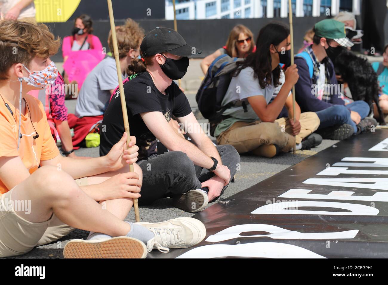 Cardiff, Wales, UK. 1st September 2020. Extinction Rebellion protestors take over Cardiff and march on the Senedd to demand a green recovery and passing of the CEE Bill on day one of a week of action. Protestors sit down in the street in central Cardiff blocking traffic Credit: Denise Laura Baker/Alamy Live News Stock Photo