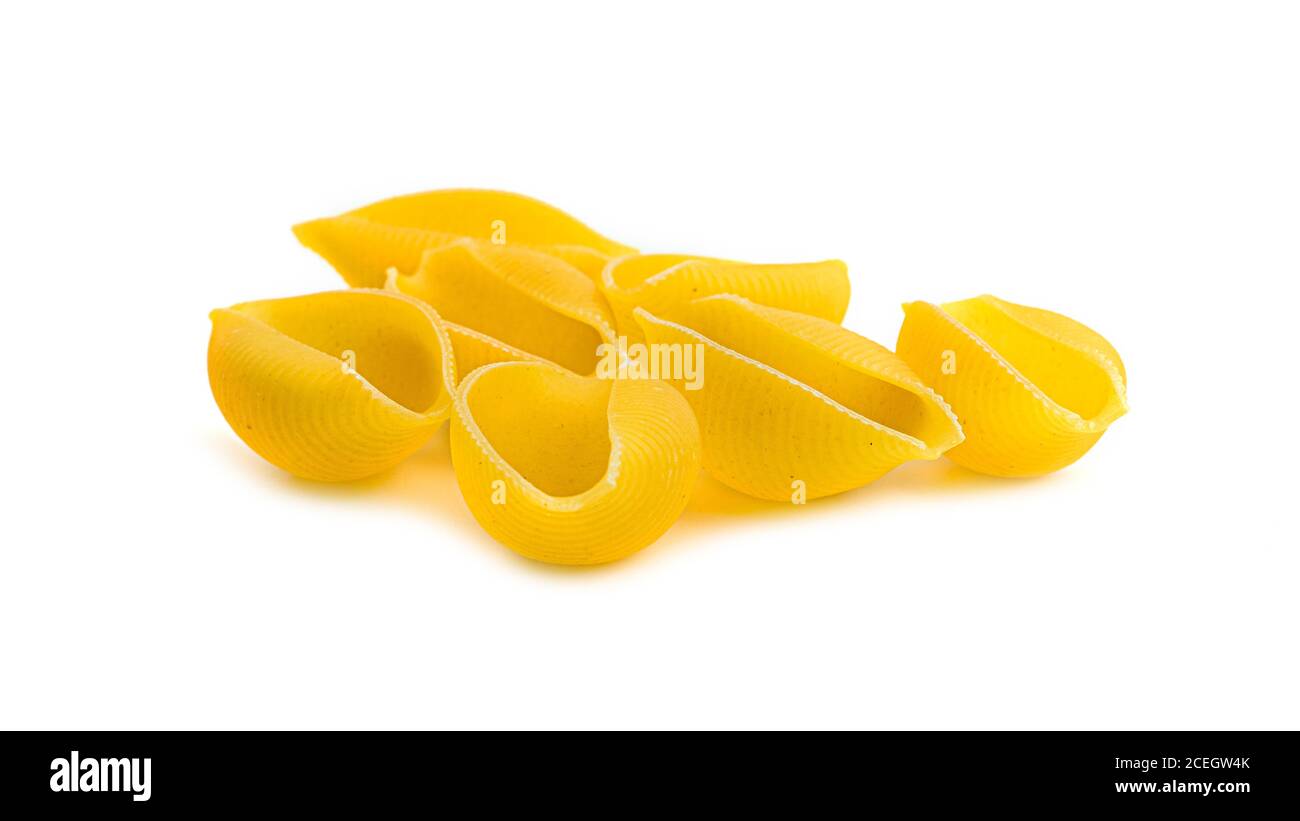 Uncooked shell pasta on white background Stock Photo - Alamy