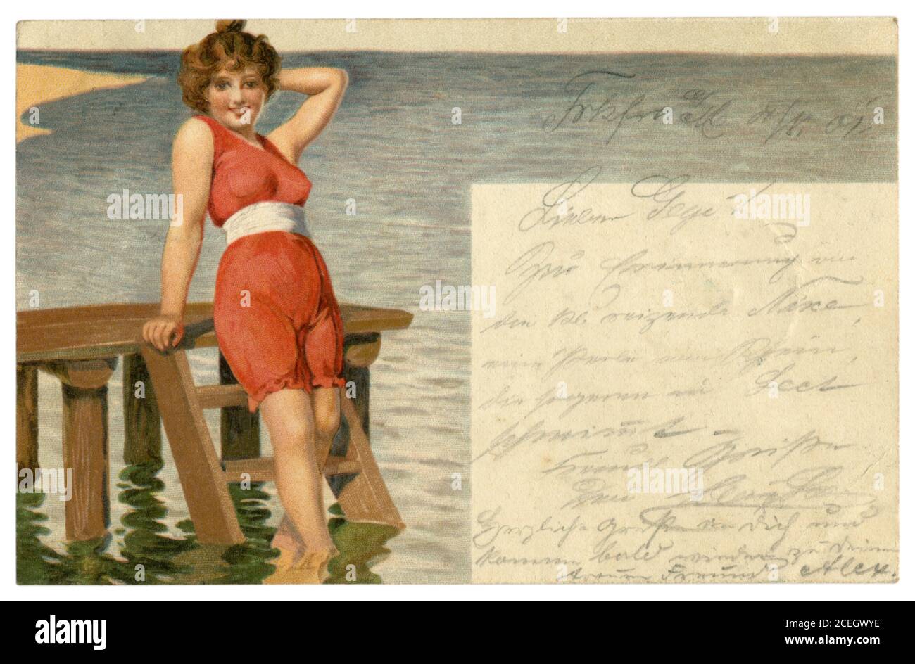 German historical postcard: Lithography: A beautiful young girl poses smiling in a red bathing suit with a white belt by the sea. Germany, 1901 Stock Photo