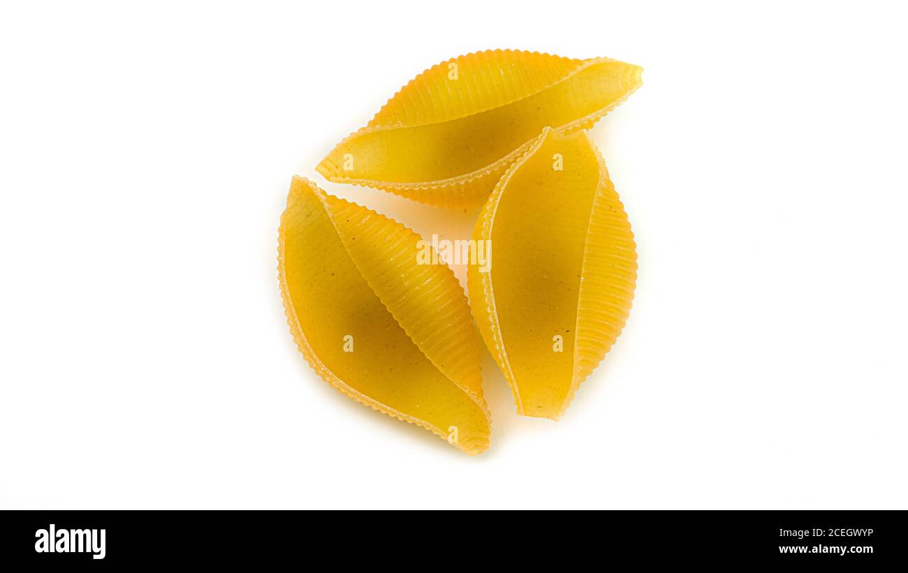 Uncooked shell pasta on white background Stock Photo - Alamy