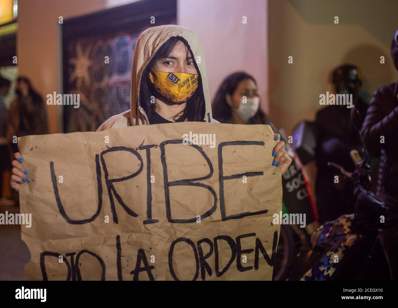 An opposition person holds a sign that says 'Uribe gave the order,' celebrating the court's ruling against former President Álvaro Uribe. Stock Photo