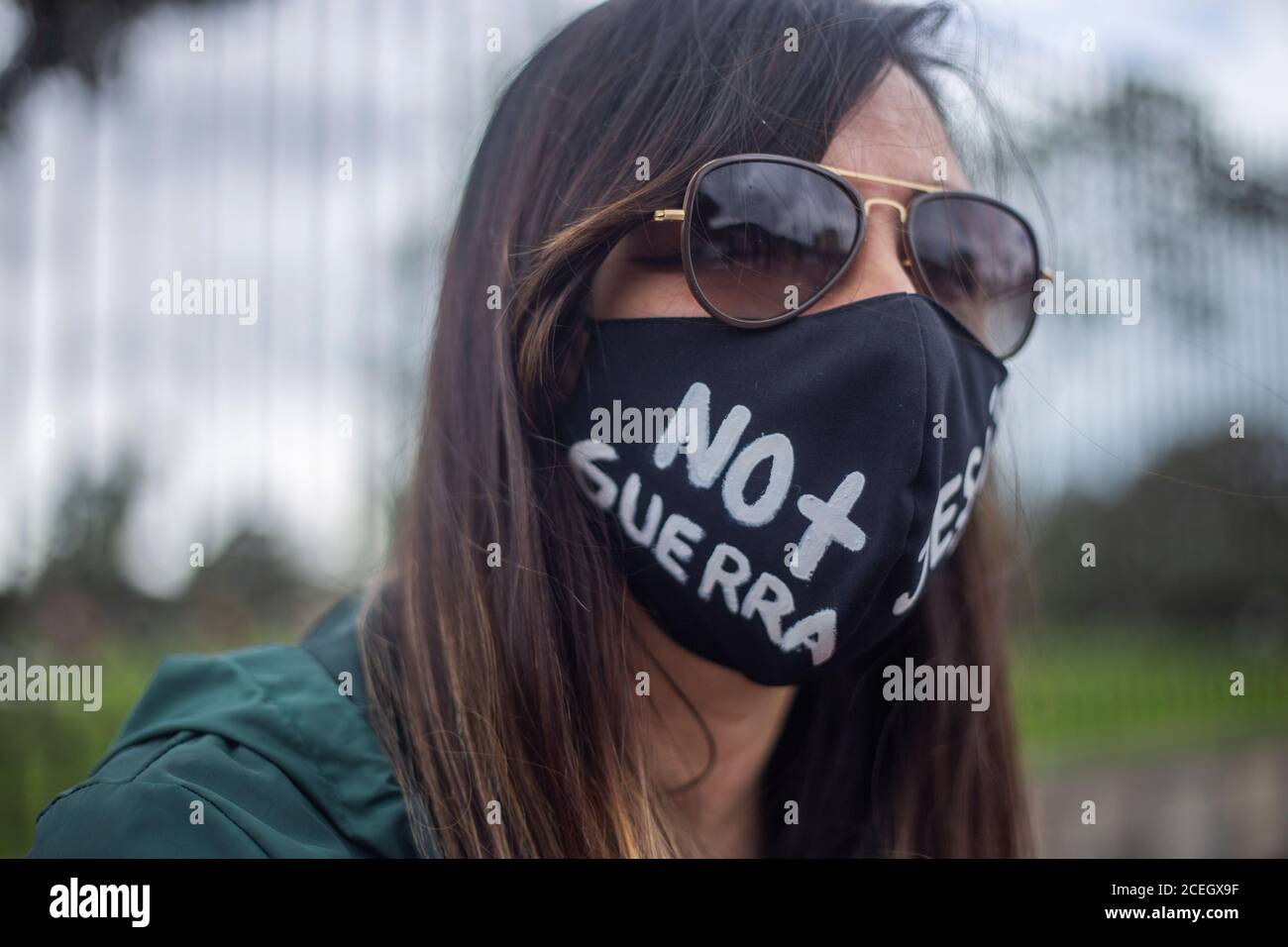 A person wears a mask that says ''no more war'' during a protest sparked by the recent massacres in Narino and Cali , in Colombia. Stock Photo