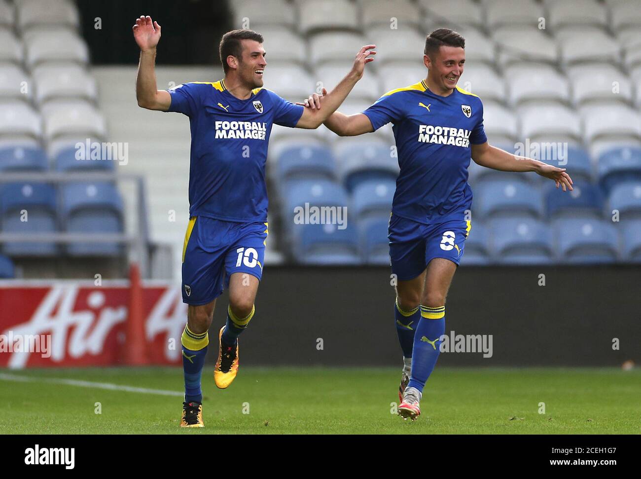 AFC Wimbledon's Adam Roscrow (left) celebrates scoring his side's first goal of the game with team-mate Anthony Hartigan during the EFL Trophy, Southern Group G match at The Kiyan Prince Foundation Stadium, London. Stock Photo