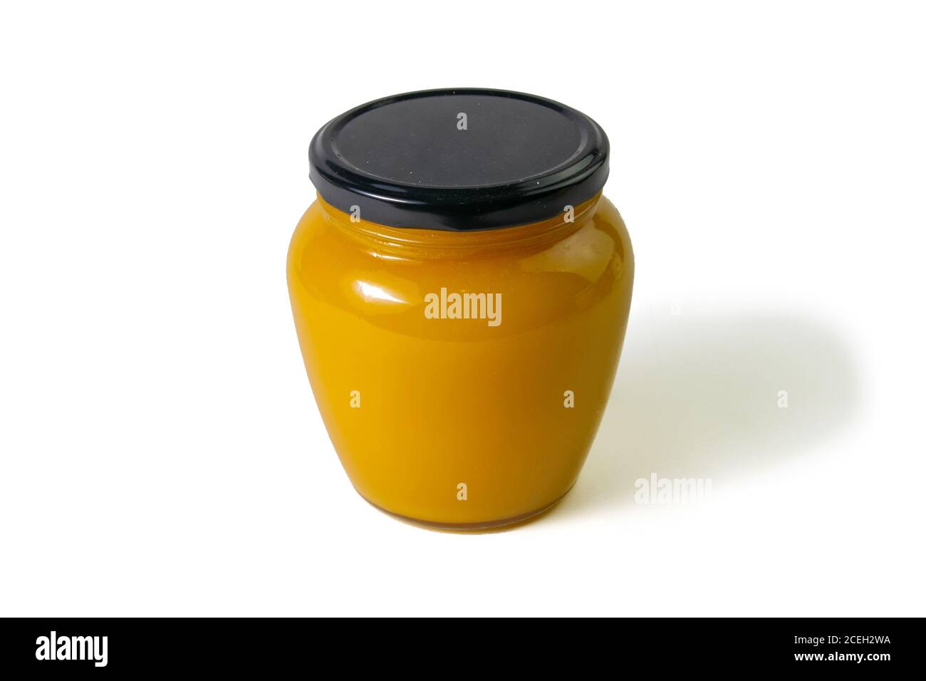 Jar of honey with flowers of acacia isolated on white background. Front views, close-up Stock Photo