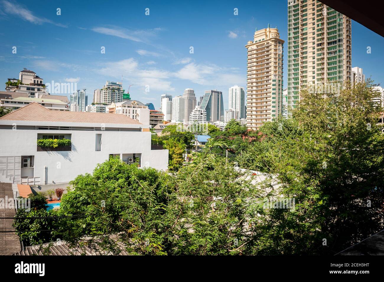 View across rooftops and towards high rise condos in central Bangkok ...
