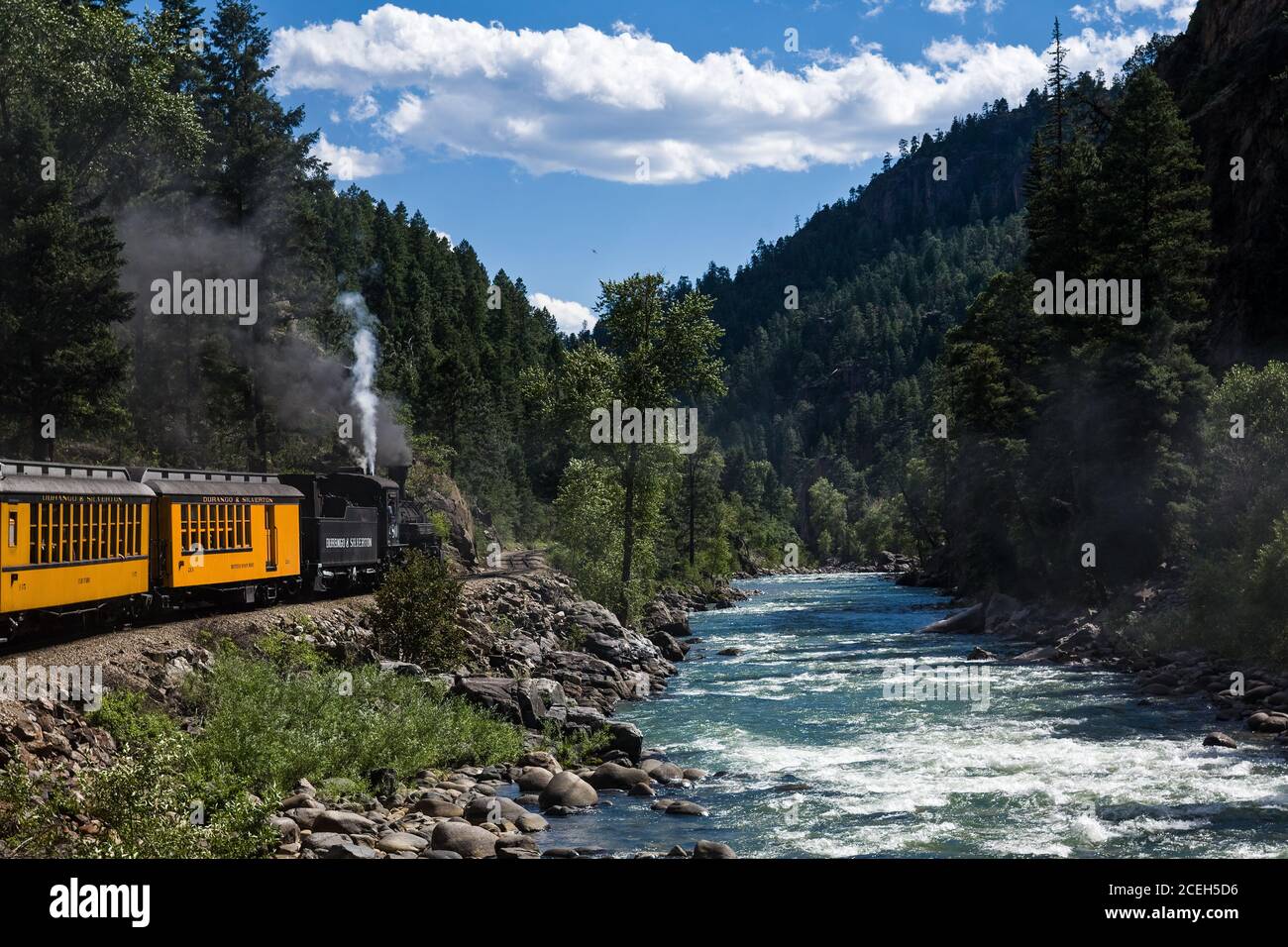 The Durango and Silverton Narrow Gauge Railroad travels along the Animas River as it passes through the San Juan Mountains  between Durango and Silver Stock Photo