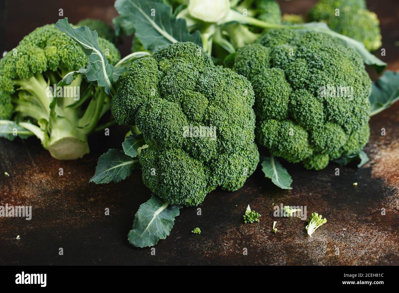 Fresh green broccoli on a dark brown background. Macro photo green fresh vegetable broccoli. Green Vegetables for diet and healthy eating. Organic foo Stock Photo