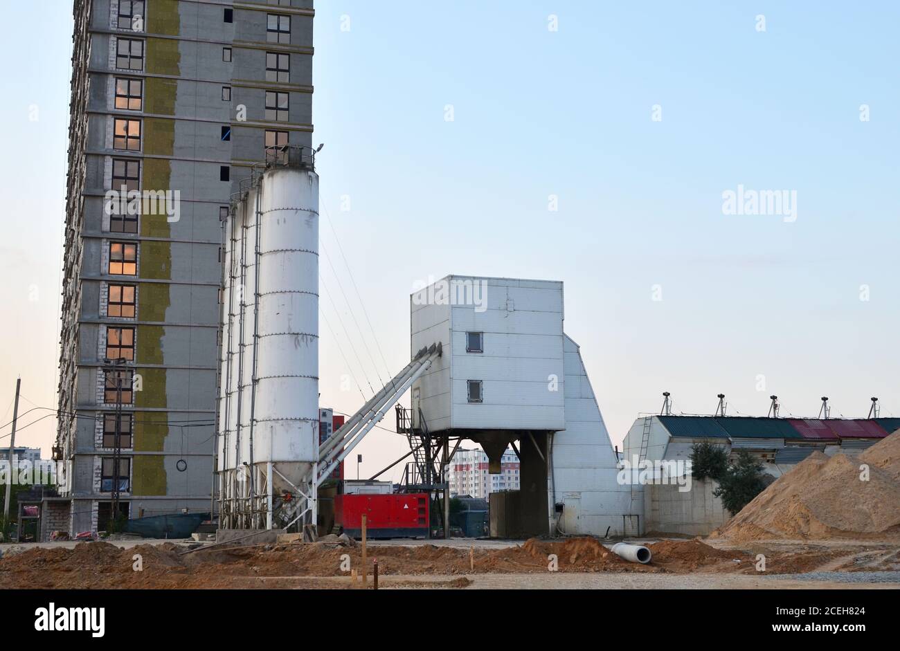 Ready mix stationary concrete batching plant on construction site. Producing сoncrete and portland cement mortar for construction industry. Constructi Stock Photo