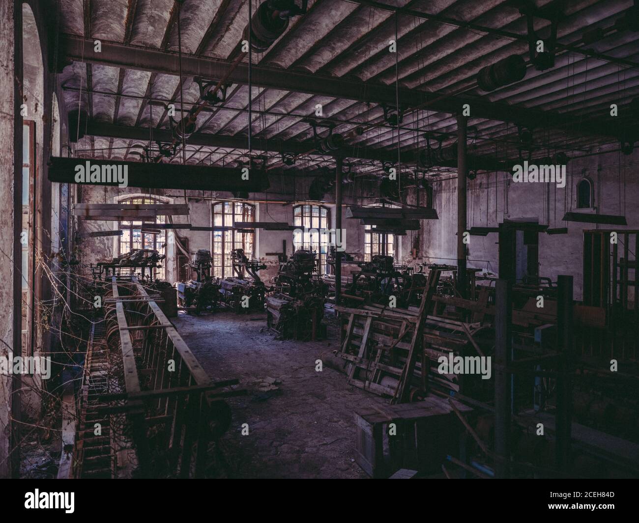 Room in old abandoned factory with rusty industrial machines. Stock Photo