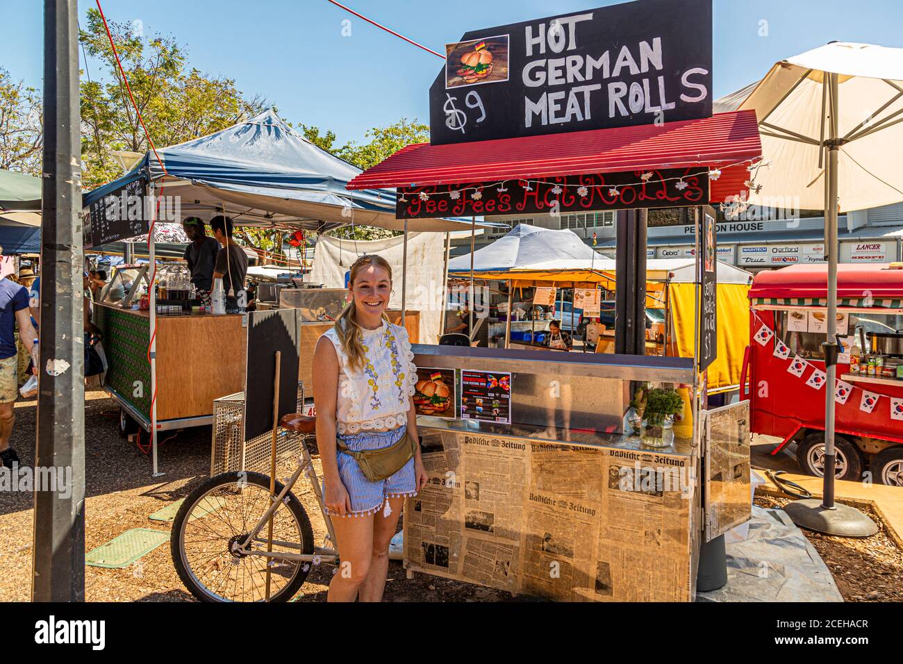 Young German entrepreneur in Australia selling Hot German Meat Rolls Stock Photo