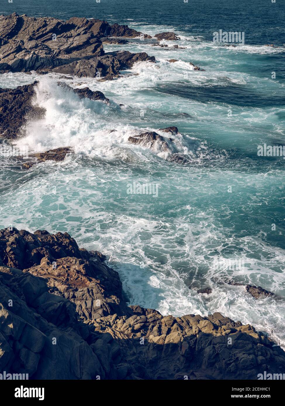 Landscape of waves crashing on the stones Stock Photo