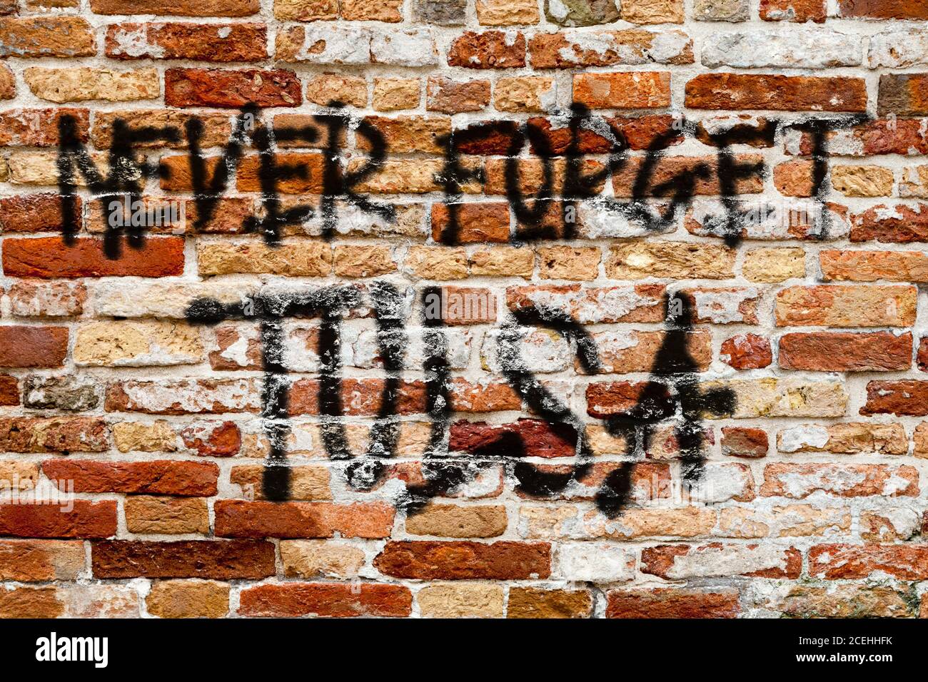 Close-up on a the phrase 'Never forget Tulsa' painted on a brick wall. Stock Photo