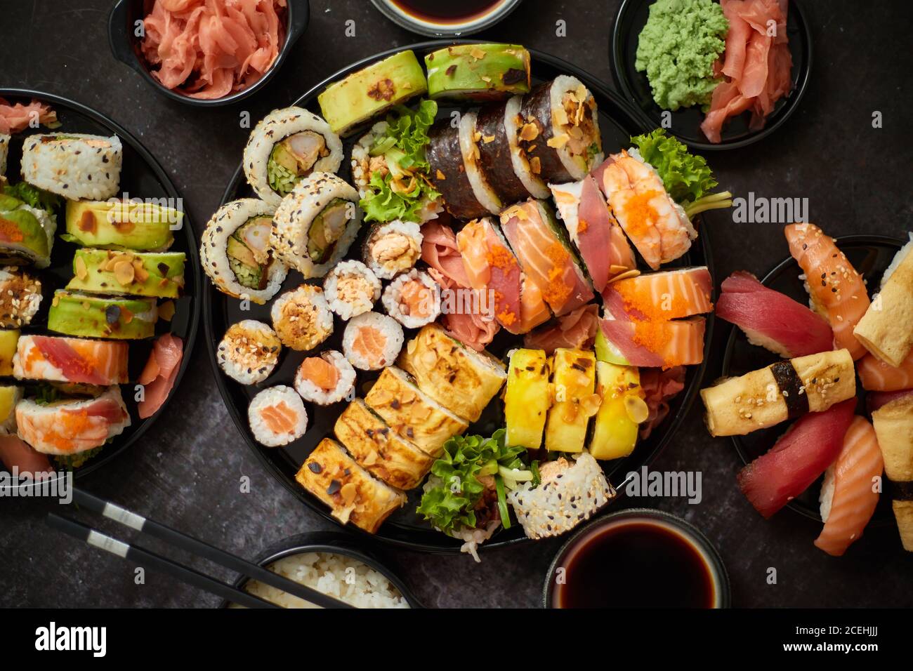 Asian food fest. sushi with nigiri, maki, uramaki on black plates. Various of sushi Stock Photo Alamy