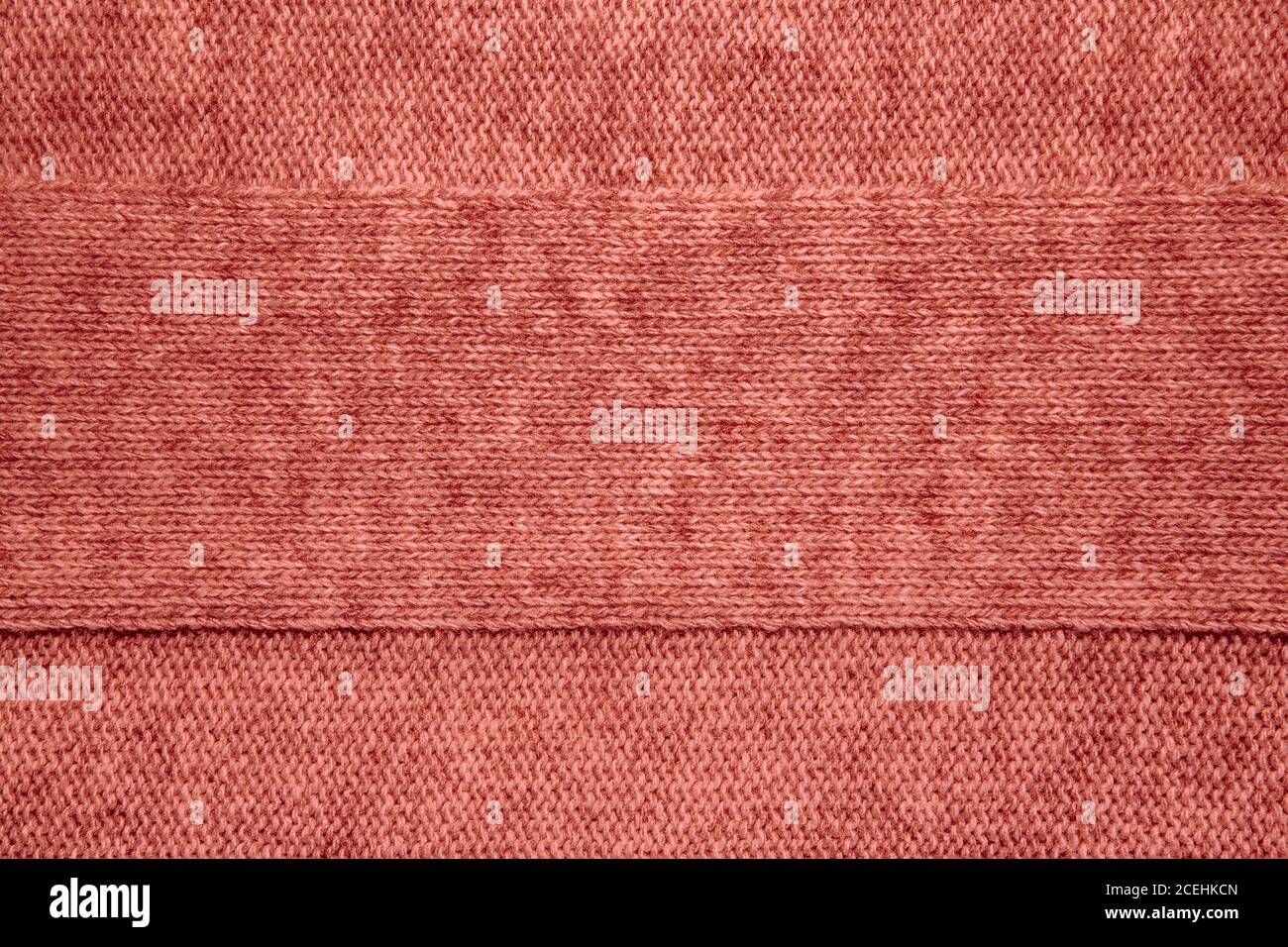 Wool sweater texture close up. Knitted jersey background with a relief pattern. Braids in machine knitting pattern Stock Photo