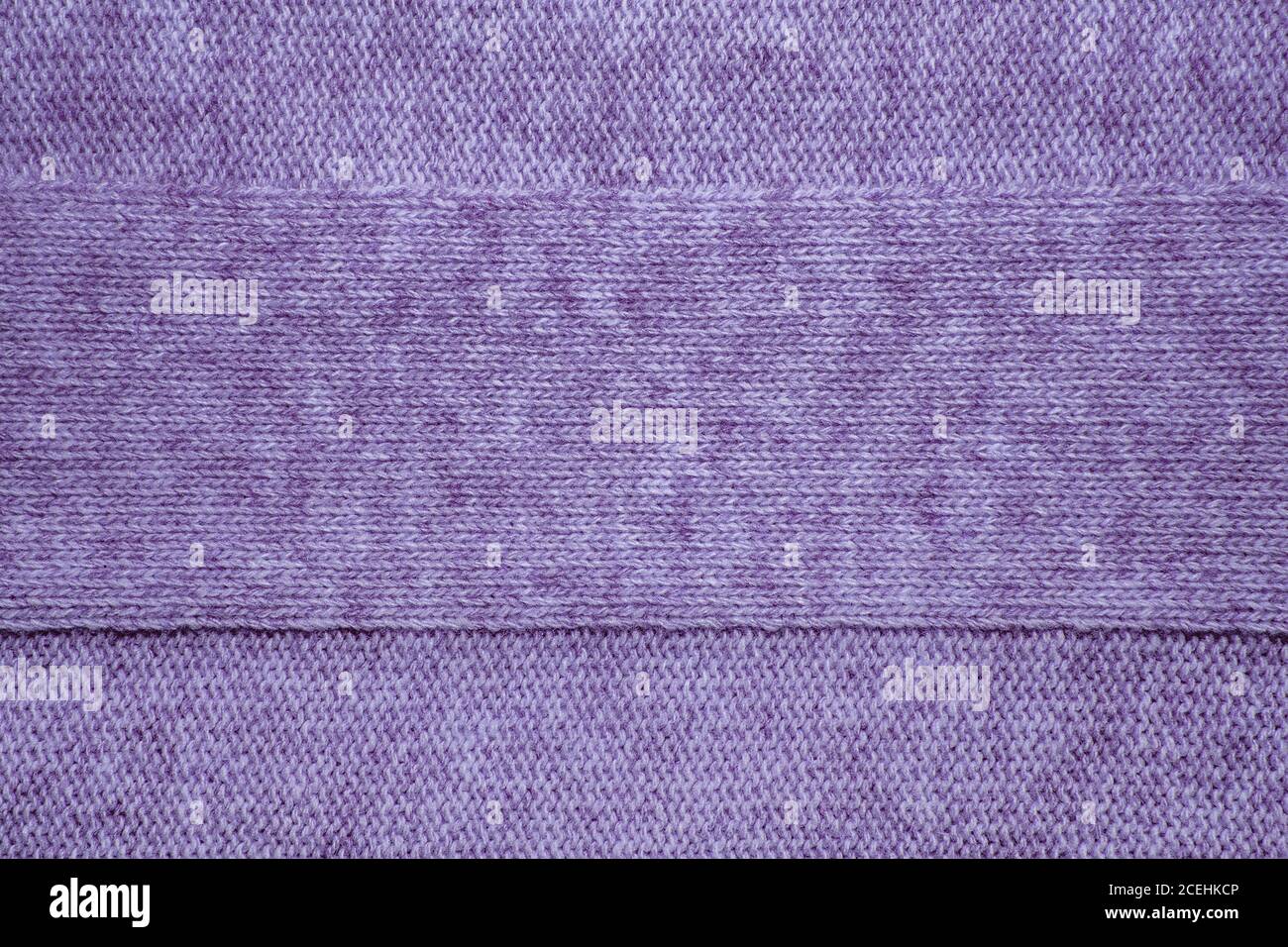 Wool sweater texture close up. Knitted jersey background with a relief pattern. Braids in machine knitting pattern Stock Photo
