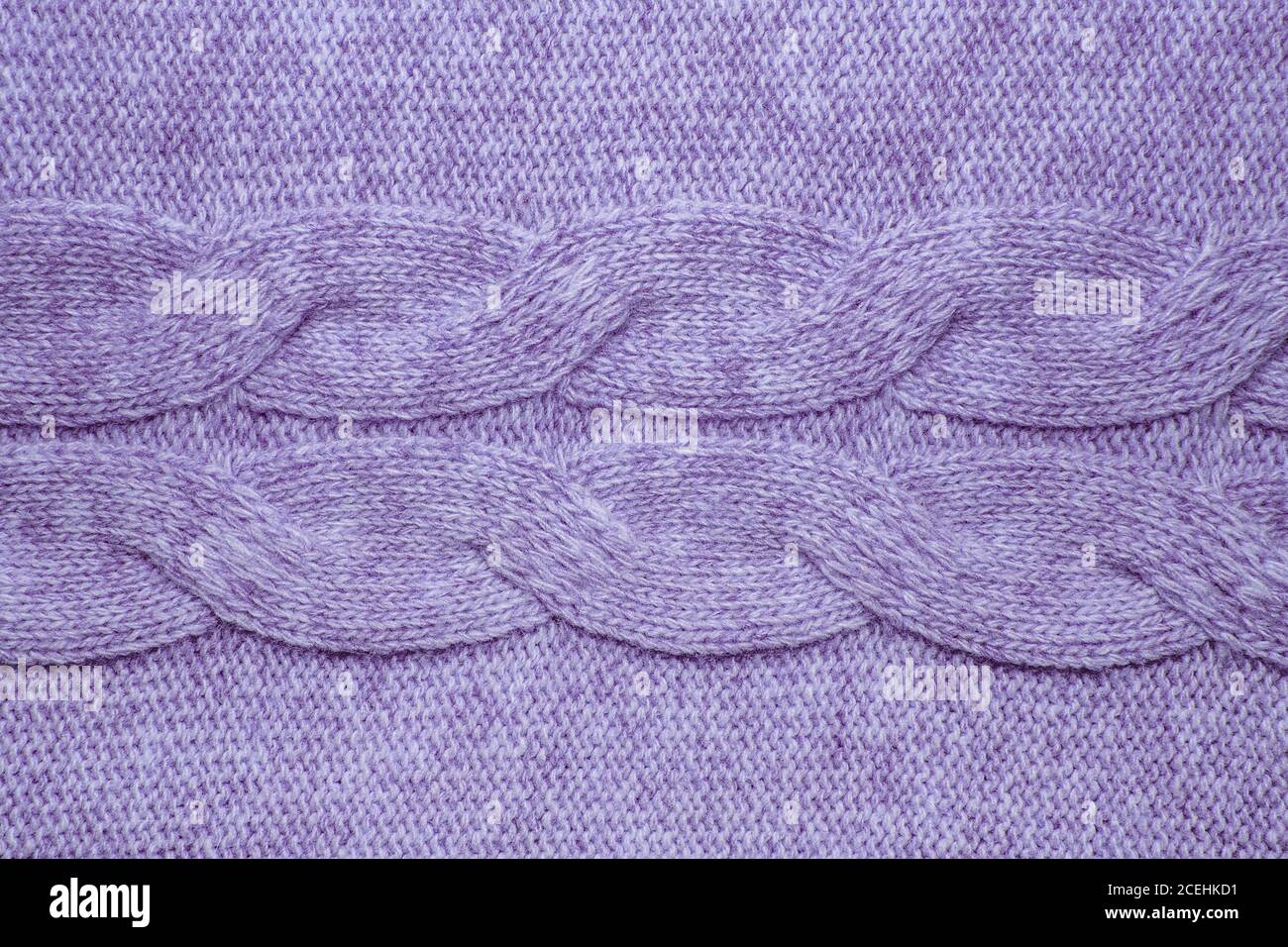 Wool sweater texture close up. Knitted jersey background with a relief pattern. Braids in machine knitting pattern Stock Photo