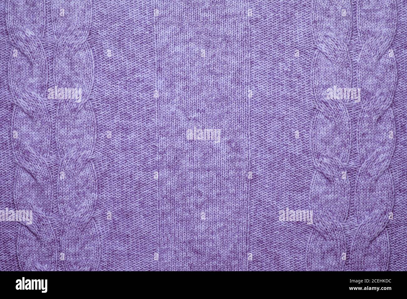 Wool sweater texture close up. Knitted jersey background with a relief pattern. Braids in machine knitting pattern Stock Photo