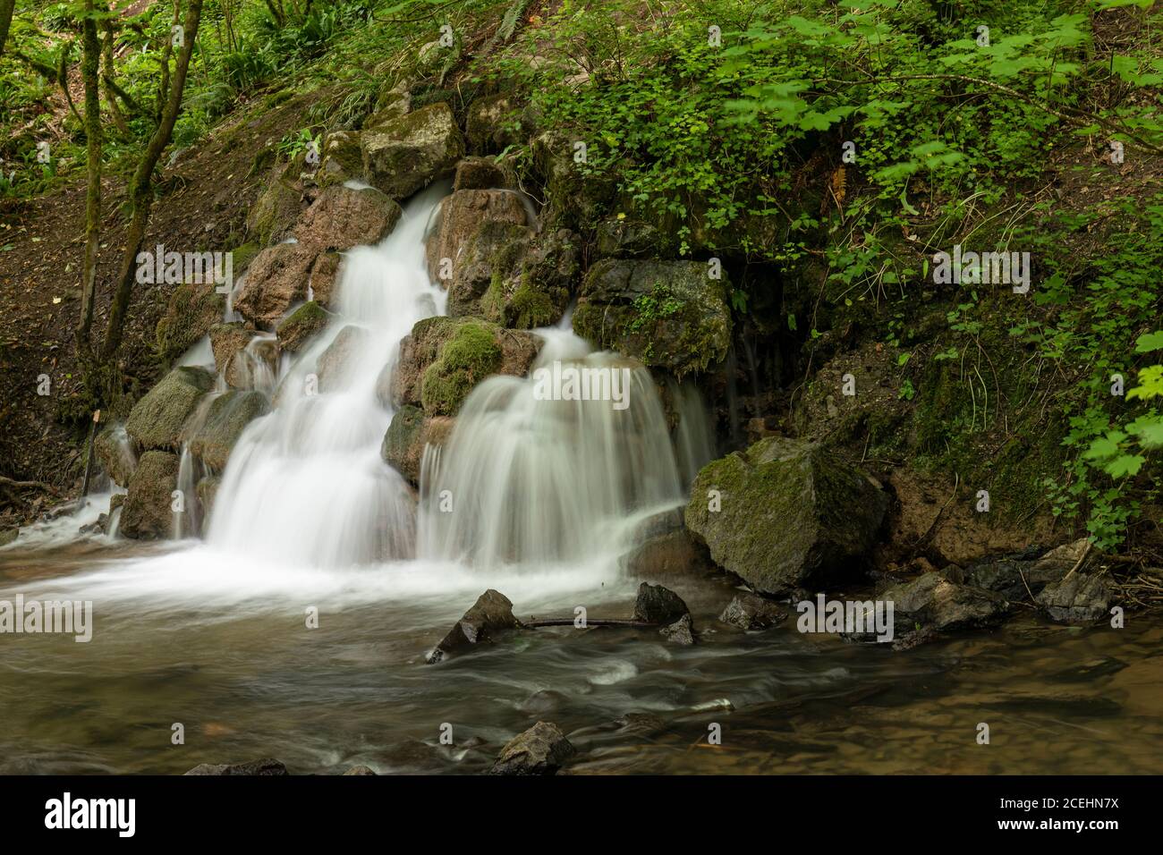 Waterfall at the Old Fussells Iron Works, Mells, Somerset, England, UK Stock Photo