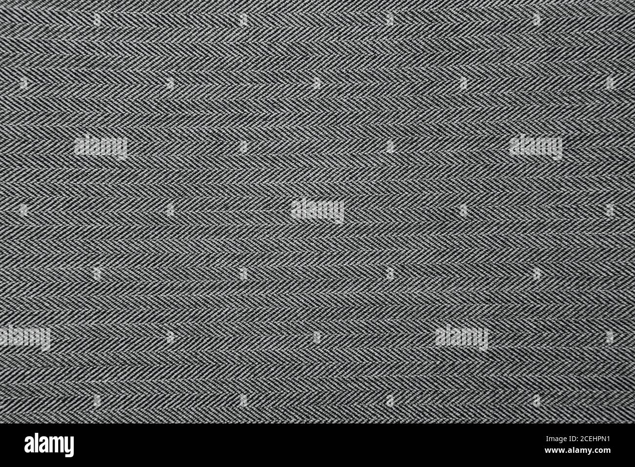 Grey herringbone fabric pattern texture background closeup Stock Photo