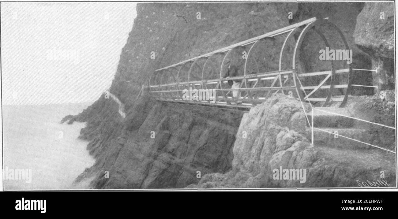 . Scientific American Volume 88 Number 12 (March 1903). PECULIAR BRIDGE CONSTRUCTION ON THE NORTH COAST OF IRELAND.. GENERAL VIEW SHOWING THE POSITION OF THE BRIDGE ON THE CLIFFS. the rocks, which would have seriously damaged it. Thestructure was, however, lifted to its position withoutmishap. It was originally intended to stay the bridgewhen in position with guys, but when the bridge waserected it was found to be sufficiently rigid to dis-pense with these additional supports. The bridgewas designed by Mr. Berkeley Wise, the chief en-gineer to the Belfast and Northern Counties Railroadof Irela Stock Photo