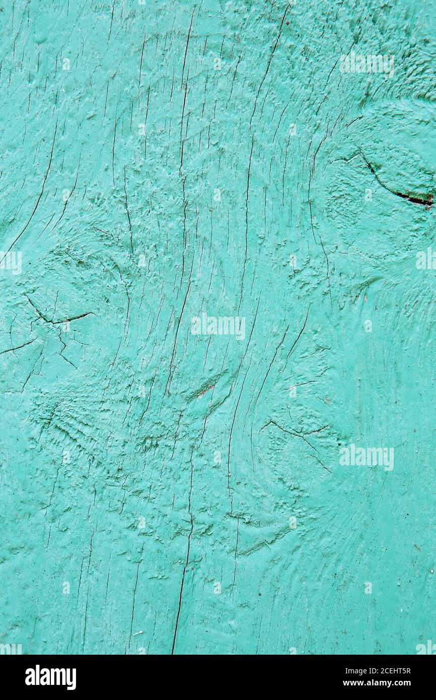 Cracking and peeling turquoise paint on a wall. Vintage wood background ...