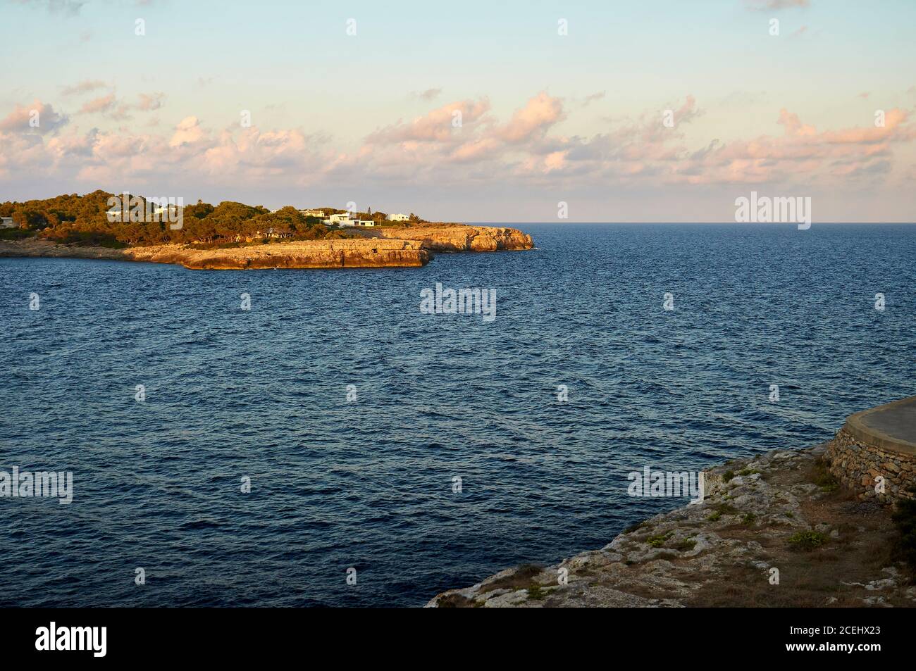 Porto Petro bay from Punta de Sa Torre cape at sunset with villas next to the coast (Santanyí, Majorca, Balearic Islands, Mediterranean sea, Spain) Stock Photo