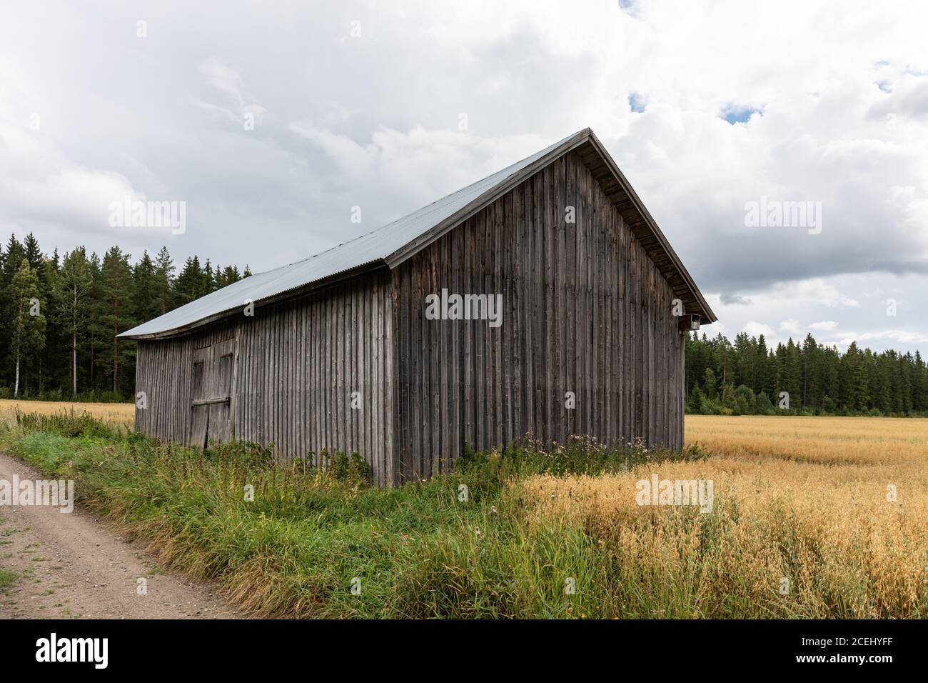 Old weathered roadside barn in rural countryside of Hauho, Finland Stock Photo