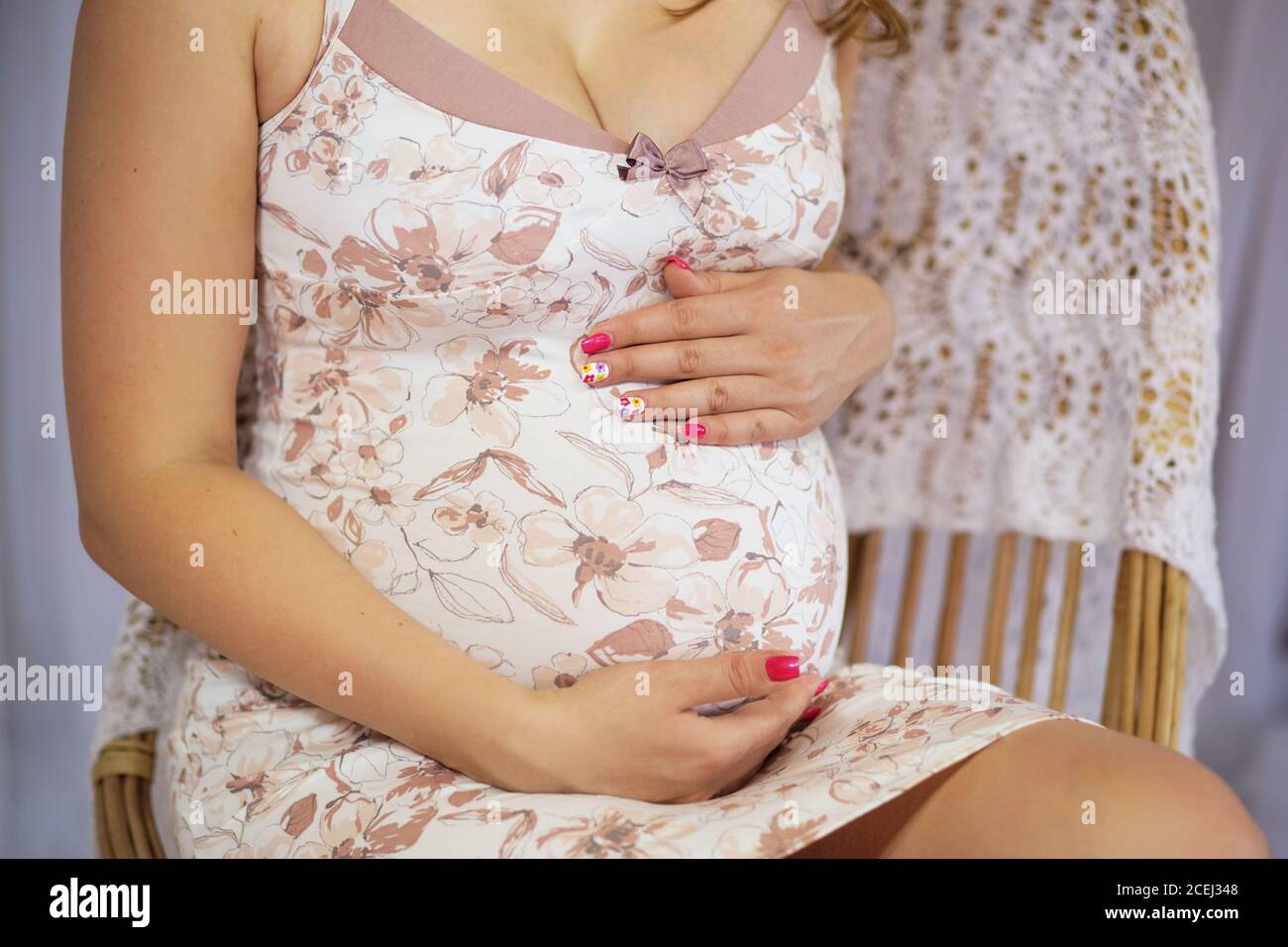 Happy Pregnant woman hugging her belly Stock Photo - Alamy