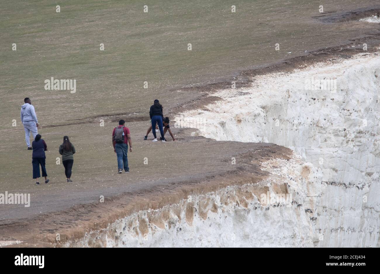 Beachy Head, Eastbourne, East Sussex, UK., . Visitors take risks near the fragile cliffs edge at the South Coast beauty spot Credit: Newspics UK South/Alamy Live News Stock Photo