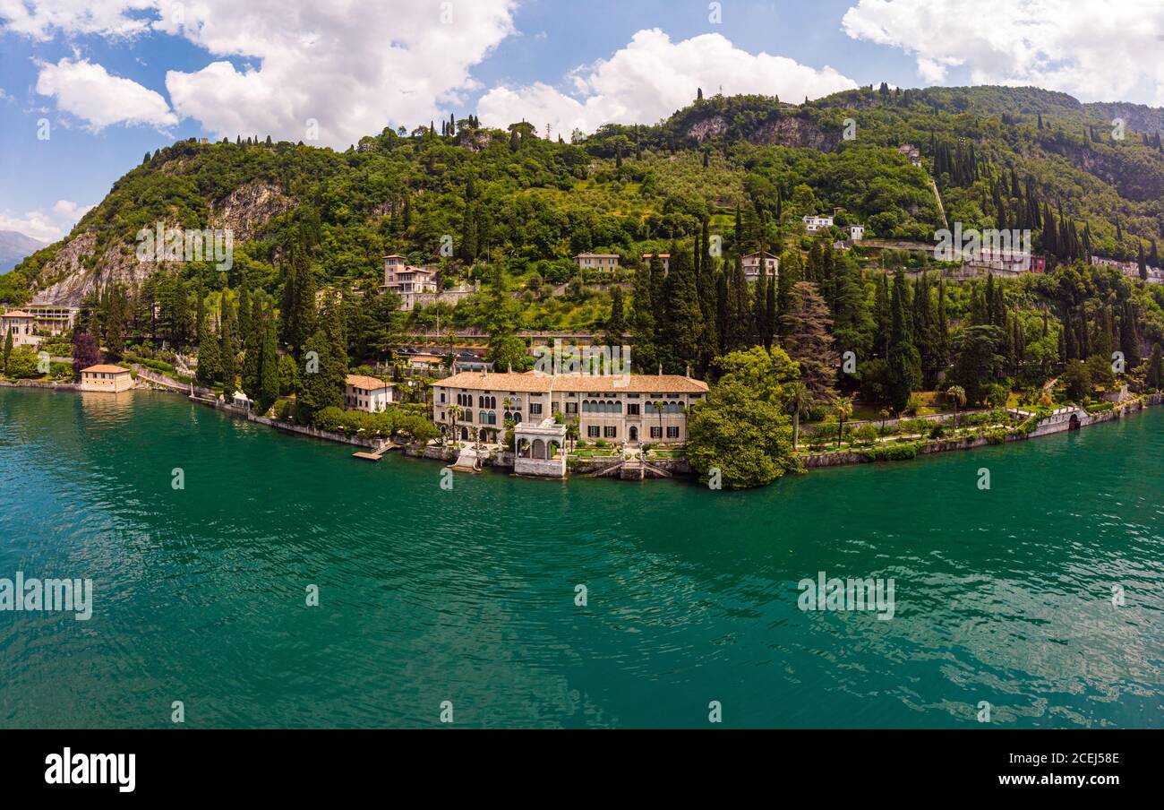 Beautifull aerial panoramic view from the drone to Varenna famous old Italy town on bank of Como lake. High top view to villa Monastero landscape Stock Photo