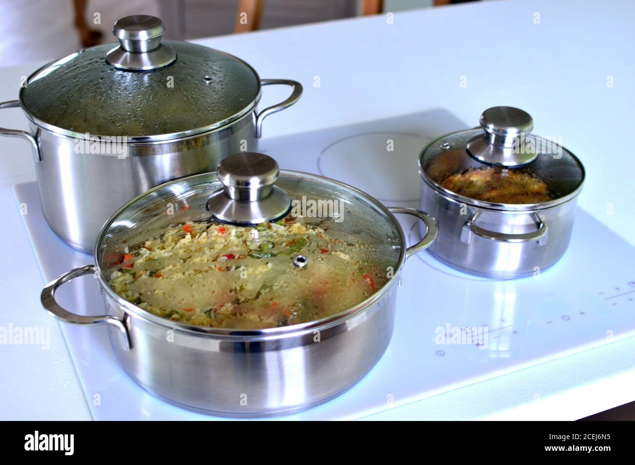 measuring temperature of fish soup during cooking in stockpot by infrared  thermometer on ceramic stove at home kitchen Stock Photo - Alamy