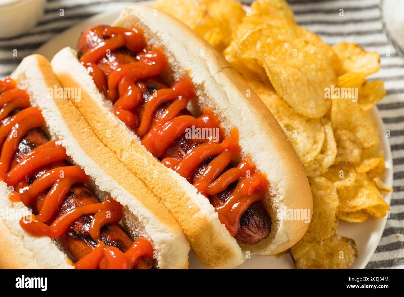 American Hot Dog with Ketchup with Potato Chips Stock Photo Alamy