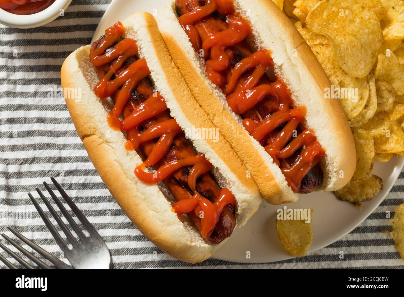 American Hot Dog with Ketchup with Potato Chips Stock Photo