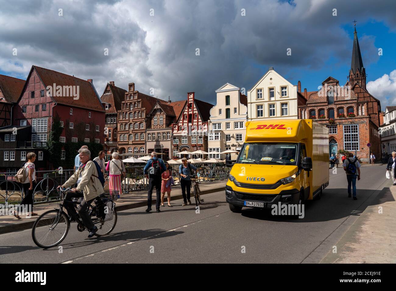 The old town of Lüneburg, Stintmarkt area at the river Ilmenau, historic harbor district, many restaurants, pubs, cafes, DHL Paketdienst Fahrzeug, Low Stock Photo