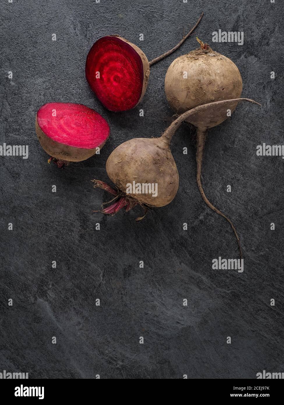 Beetroot cut in half on dark table. Overhead shotm with copy space. Stock Photo