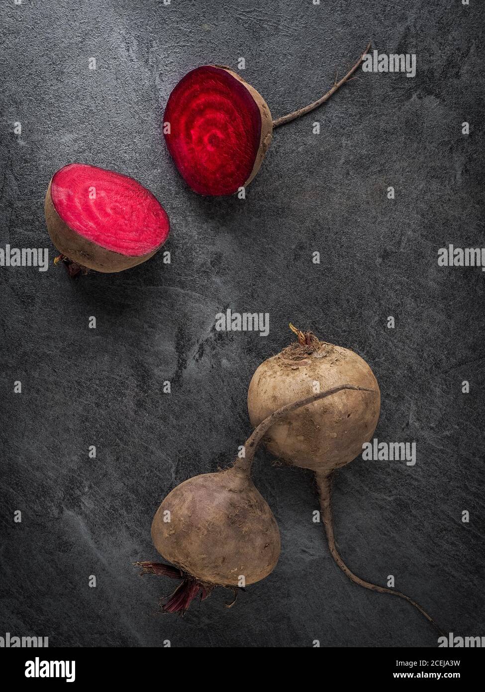 Beetroot cut in half on dark table. Overhead shot with copy space. Dark food photo. Stock Photo
