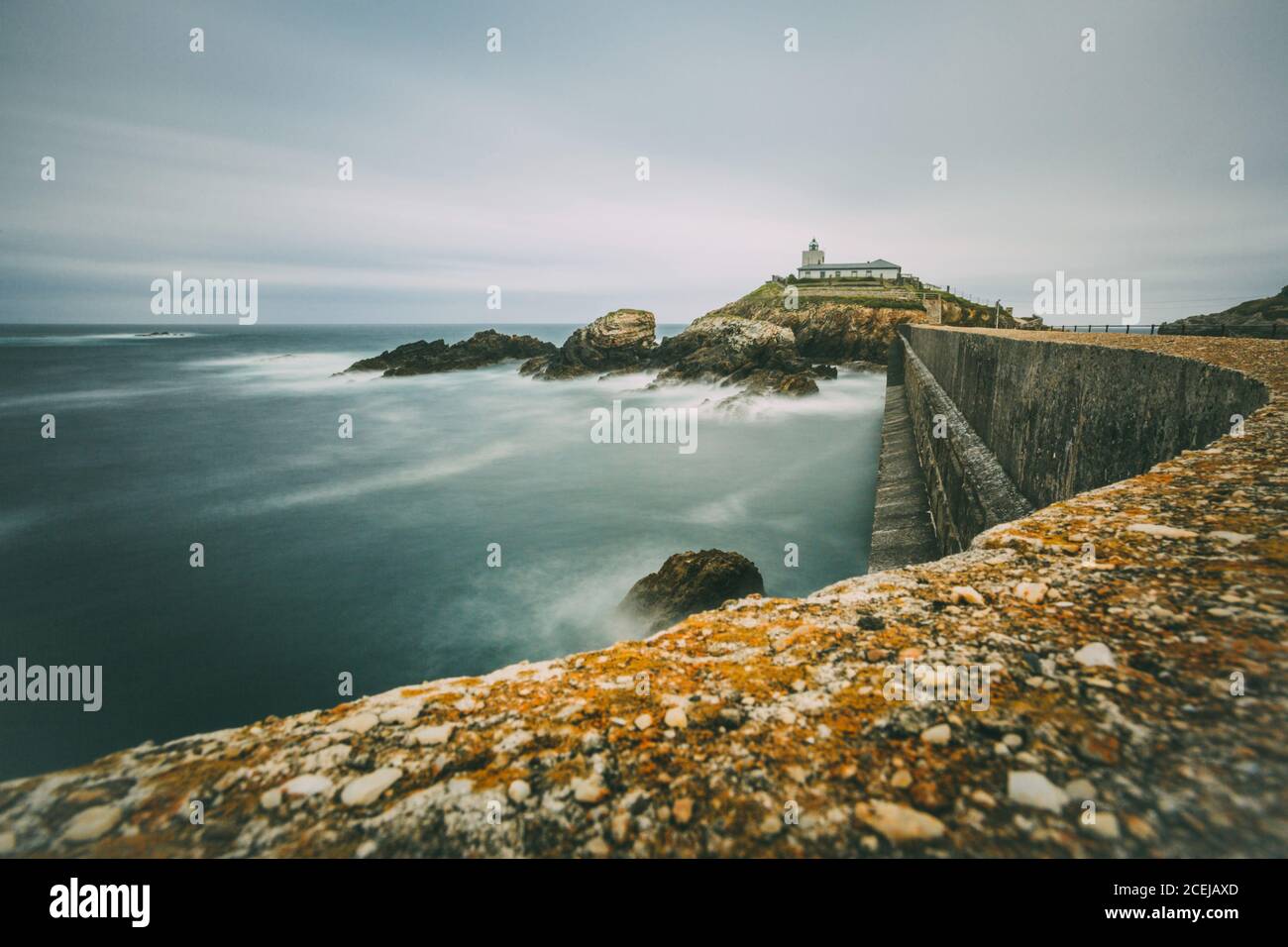 Long exposure of Cantabrian sea with lighthose Stock Photo