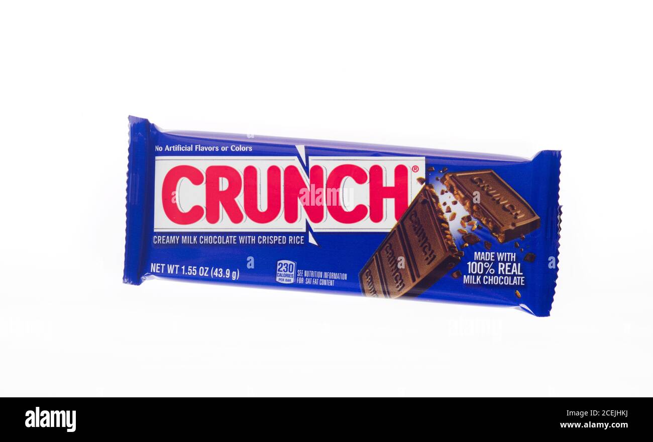 United States Crunch candy bar by Ferrara Candy Company, part of Ferrero,  with crisped rice and milk chocolate in wrapper on white-new packaging Stock Photo