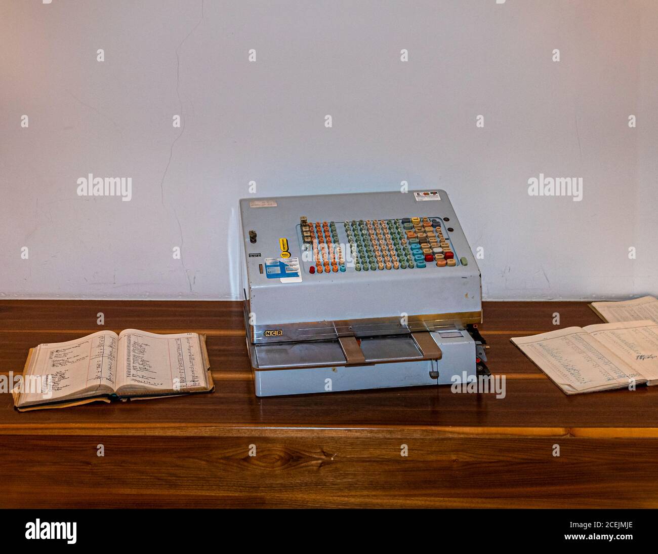 Mechanical booking machine as cash register and opened cash book in museum of Hotel Lenkerhof, Lenk, Switzerland Stock Photo