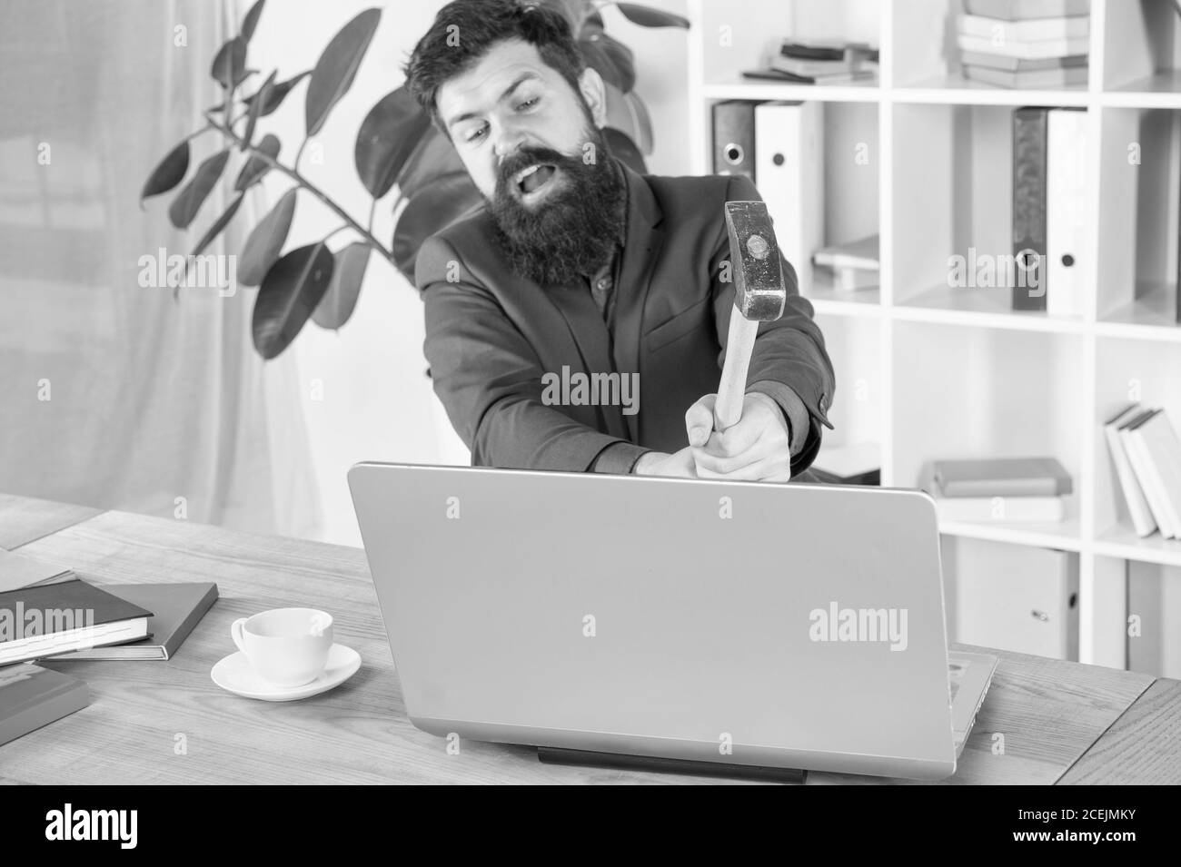 Lagging system. Hate office routine. Man bearded crush computer. Software license agreement. Destroy laptop. Hateful job. Bad computer. Slow internet connection. Outdated software. Computer lag. Stock Photo