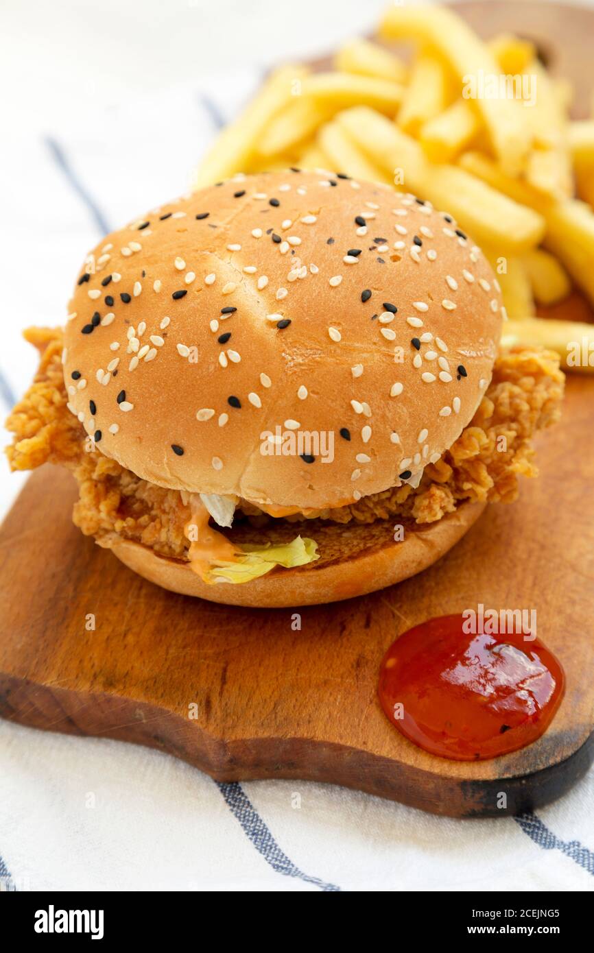 Homemade Chicken Strips Burger with French Fries and soursweet sauce