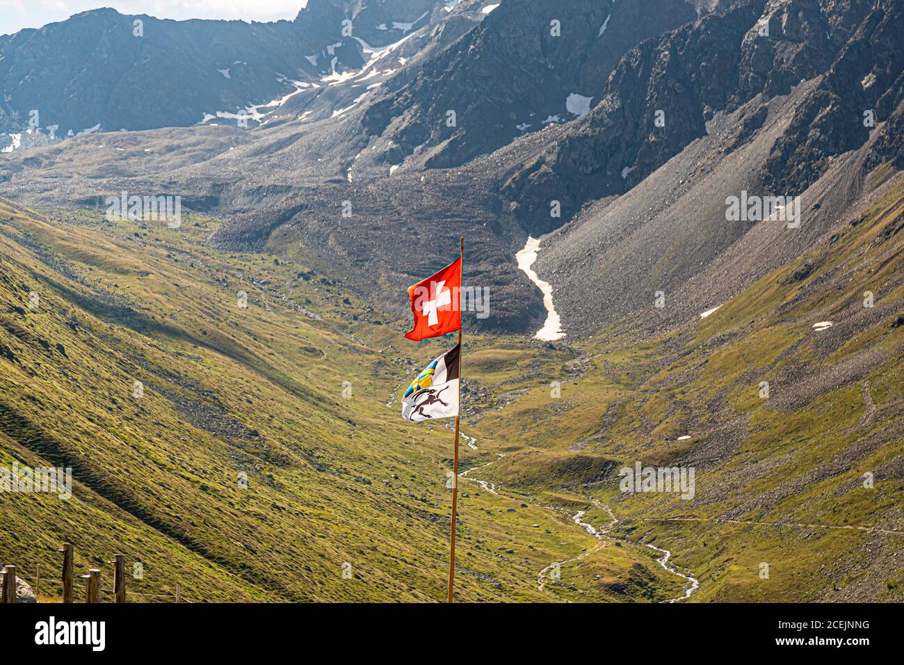 Flag of the Canton of Graubuenden. The flag of the Canton of the Grisons consists of three parts and thus recalls the three confederations from which the present canton emerged. The black ibex as the emblem of the covenant of God, the divided field for the gray covenant and the blue-yellow cross for the ten-judge covenant. Switzerland Stock Photo